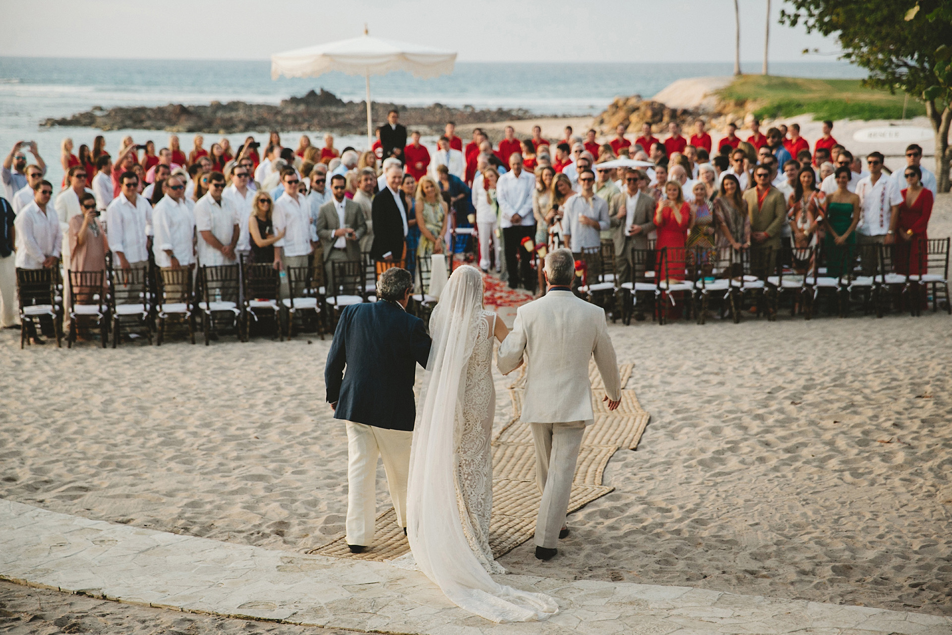 bride walking down isle at beach wedding